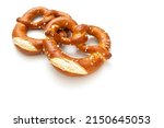 Small photo of Homemade pretzels as a tasty salty snack isolated on white background