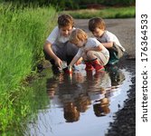 Three Boy Play In  Puddle
