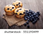 muffin with blueberries on a wooden table. fresh berries and sweet pastries on the board