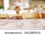 Empty white marble table with blur cafe background.