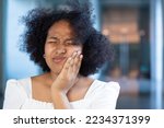 Small photo of African woman suffering from toothache, tooth decay, tooth sensitivity, wisdom tooth pain, cavity, dental care concept
