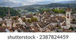 Small photo of Panoramic view of the Swiss town of Schaffhausen with the spire of St. Johann Reformed Church on the right and the tower of the Schaffhausen City Library on the left.