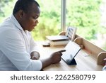 Male African doctor talking on conference video call to patient . virtual therapist consulting  patients online on tablet, Tele medicine chat
