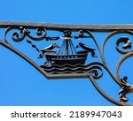 Small photo of Close-up detail of a street lamp in the historic city of Lisbon in Portugal. The design of the lamp shows a boat with two birds facing eachother - the symbol of the city.