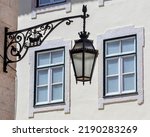 Small photo of Ornate street lamp in the historic city of Lisbon in Portugal. The design of the lamp shows a boat with two birds facing eachother - the symbol of the city.