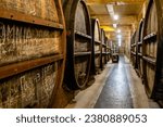 Small photo of Yerevan, Armenia - October 2, 2023: big brandy barrels in NOY brandy factory basement in Yerevan. Noy is the oldest Yerevan factory for production of Armenian cognac, it was founded in 1877