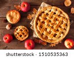 Homemade autumn apple pies, top view table scene with a rustic wood background