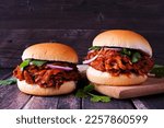 Small photo of Jack fruit meatless burgers against a dark wood background. Healthy eating, plant-based pulled pork meat substitute concept.