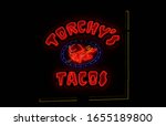 Small photo of Tyler, TX - December 25, 2018: Torchy's Tacos Neon Sign lit at night, located on Loop 323 in Tyler TX
