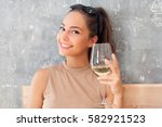 Portrait of a brunette beauty drinking wine.