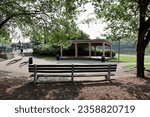 Small photo of The empty park bench in front of the bandstand in the park.