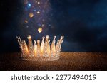 Small photo of low key image of beautiful queen or king crown over glitter table. fantasy medieval period