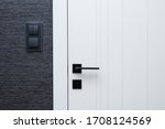 Modern interior design details - door, black switches and wallpaper