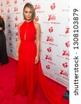 Small photo of New York, NY - February 7, 2019: Nathalie Kelley wearing dress by Randi Rahm attends The American Heart Association's Go Red for Women Red Dress Collection 2019 at Hammerstein Ballroom