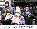 Small photo of New York, NY - December 28, 2021: People holding papers with messages to burn in the incinerator set in Latin America tradition in the middle of Times Square during Good Riddance Day