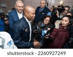 Small photo of Mayor Eric Adams helps distribute donated food and clothing to families of asylum seekers housed in the city at public school 20 in New York on February 11, 2023