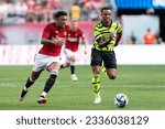 Small photo of Gabriel Magalhaes (6) of Arsenal FC and Jadon Sancho (25) of Manchester United chase the ball during friendly game at MetLife stadium in East Rutherford, NJ on July 22, 2023.