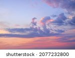 Clear sky, glowing cirrus and cumulus clouds after the storm, soft sunlight. Dramatic sunset cloudscape. Meteorology, weather, climate, heaven, peace. Graphic resources. Picturesque panoramic scenery