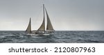 Small photo of Old expensive vintage two-masted sailboat (yawl) close-up, sailing in an open sea during the storm. Reefed sails. Sport, regatta, cruise, tourism, recreation, transportation. Panoramic view, seascape