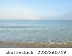 Baltic sea in a morning fog at sunrise. Soft sunlight, glowing sky, golden hour. Picturesque panoramic scenery. Nature, environment, weather, travel destinations, tourism concepts