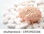 Nootropics use to improve memory and neural function, smart drugs and cognitive enhancers conceptual idea with brain and pills isolated on white background