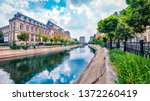 Small photo of Amazing morning cityscape of Bucharest city - capital of Romania, Europe. Colorful summer view of Court of Appeal Building on tne Dambovita river. Traveling concept background.