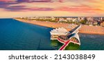 Small photo of Sunrise on public beach at early Auguast morning. Colorful summer cityscape of Lignano Sabbiadoro town. Stunning outdoor scene of Adriatic coast of Italy, Europe. Vacation concept background.
