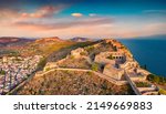 Fantastic summer view from flying drone of fortress of Palamidi. Stunning evening view of Peloponnese peninsula, Greece, Europe. Aerial cityscape of Nafplion town. Traveling concept background.