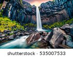 Dramatic morning view of famous Svartifoss (Black Fall) Waterfall. Colorful summer sunrise in Skaftafell, Vatnajokull National Park, Iceland, Europe. Artistic style post processed photo.