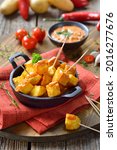 Small photo of Spanish patatas bravas with spicy chili sauce, a traditional appetizer and bar food