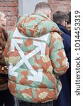 Small photo of MILAN - JANUARY 15: Man with green and brown Off White padded jacket before Fendi fashion show, Milan Fashion Week street style on January 15, 2018 in Milan.