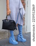 Small photo of MILAN, ITALY - JANUARY 14, 2023: Woman with Fendi dress, boots and black leather bag