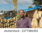 Small photo of entrepreneurship small business in the village, african street vendor selling broomsticks in the township