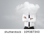 Young businessman with head in the clouds