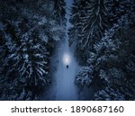 Lonely man walking throght the forest during winter night