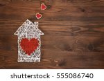 Home sweet home. Handmade home symbol with heart shape on wooden background with copy space