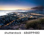 Cityscape of illuminated Townsville and ocean at dusk, Australia