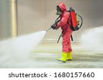 medical officers prepare hazmat (hazardous material) suits and working in airport area to cleaning virus with anti bacteria chemical