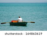 Mature Adult Man Rowing A Small ...