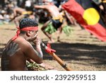 Small photo of LAURA,QLD - JULY 08 2023:Indigenous Australians dance with Australian Aboriginal Flag in Laura Quinkan Dance Festival Cape York Queensland Australia.The flag have special legal and political status