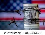 Small photo of Barbed wire against US Dollar bancnotes as symbol of economic warfare, sanctions and embargo busting.