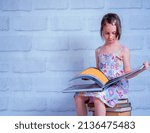 Small photo of Portrait of young beautiful young girl reading the book. The concept: the thirst for knowledge.