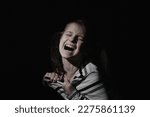 Small photo of Conceptual image: pain in children. Psychological portrait of nervous and overexcited young girl screams.