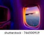 Beautiful scenic city view of sunset through the aircraft window. Image save-path for window of airplane.