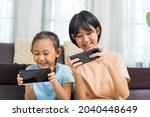 happy asian girl with sister... | Shutterstock . vector #2040448649