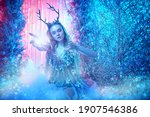 Fairy world. Beautiful forest nymph in a magical winter forest covered with snow. 