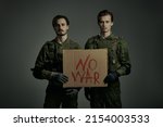 No War concept. Courageous soldiers in Protective Combat Uniform hold a sign 