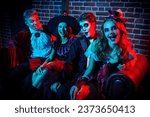 Small photo of Portrait of teenage friends in carnival costumes have fun celebrating Halloween. Skeleton, witch, clown and vampire. Merry Halloween party.