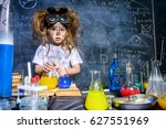 Funny little girl doing experiments in the laboratory. Explosion in the laboratory. Science and education.