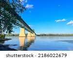 The Princess Margaret Bridge over the Saint John River in Fredericton, New Brunswick Canada on a sunny evening  with calm water